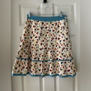 Isis pleated skirt with leaves print in a mod pattern, satin like accent size 2